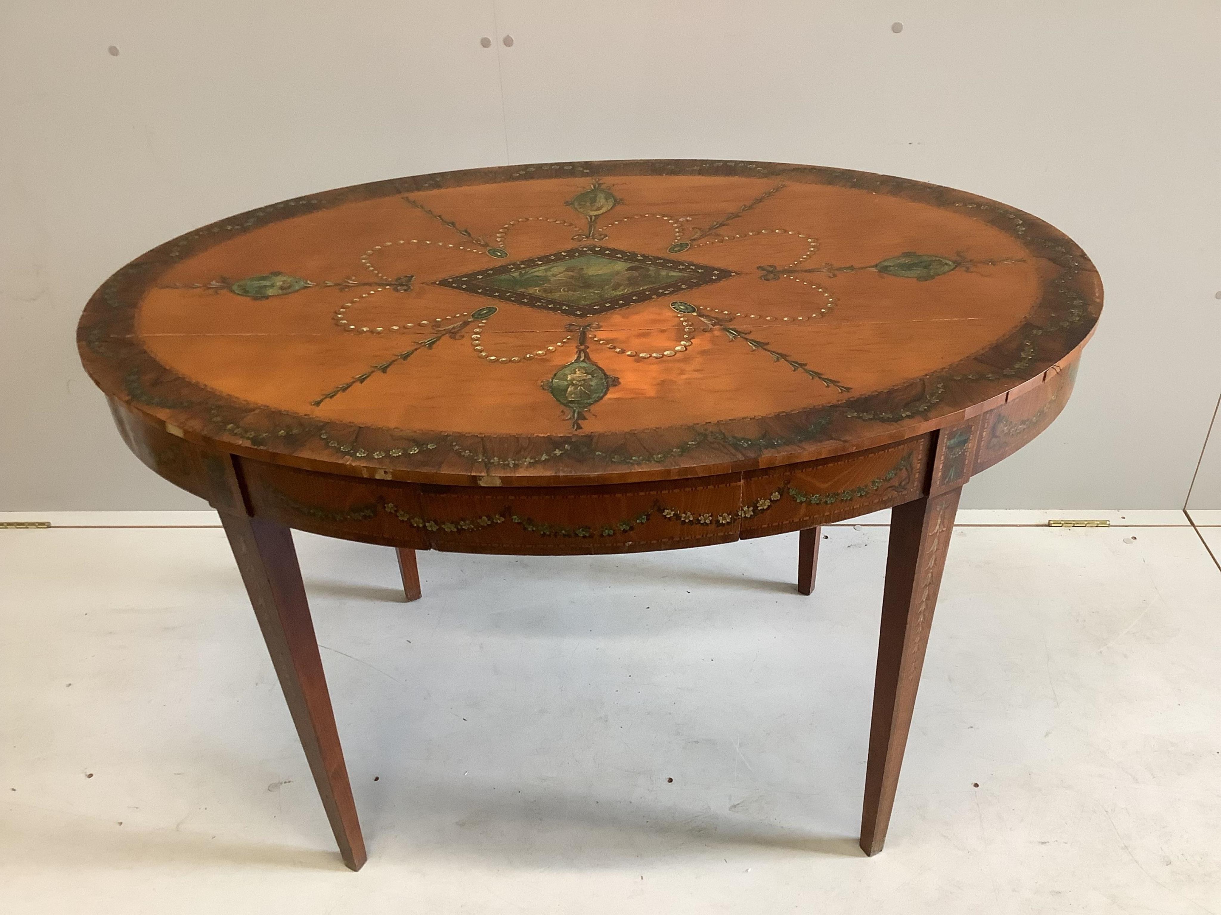 An Edwardian Sheraton revival painted satinwood oval centre table, width 117cm, depth 80cm, height 74cm. Condition - poor